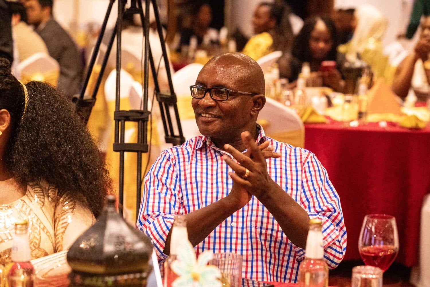 A guest sharing a laugh over dinner at the gala