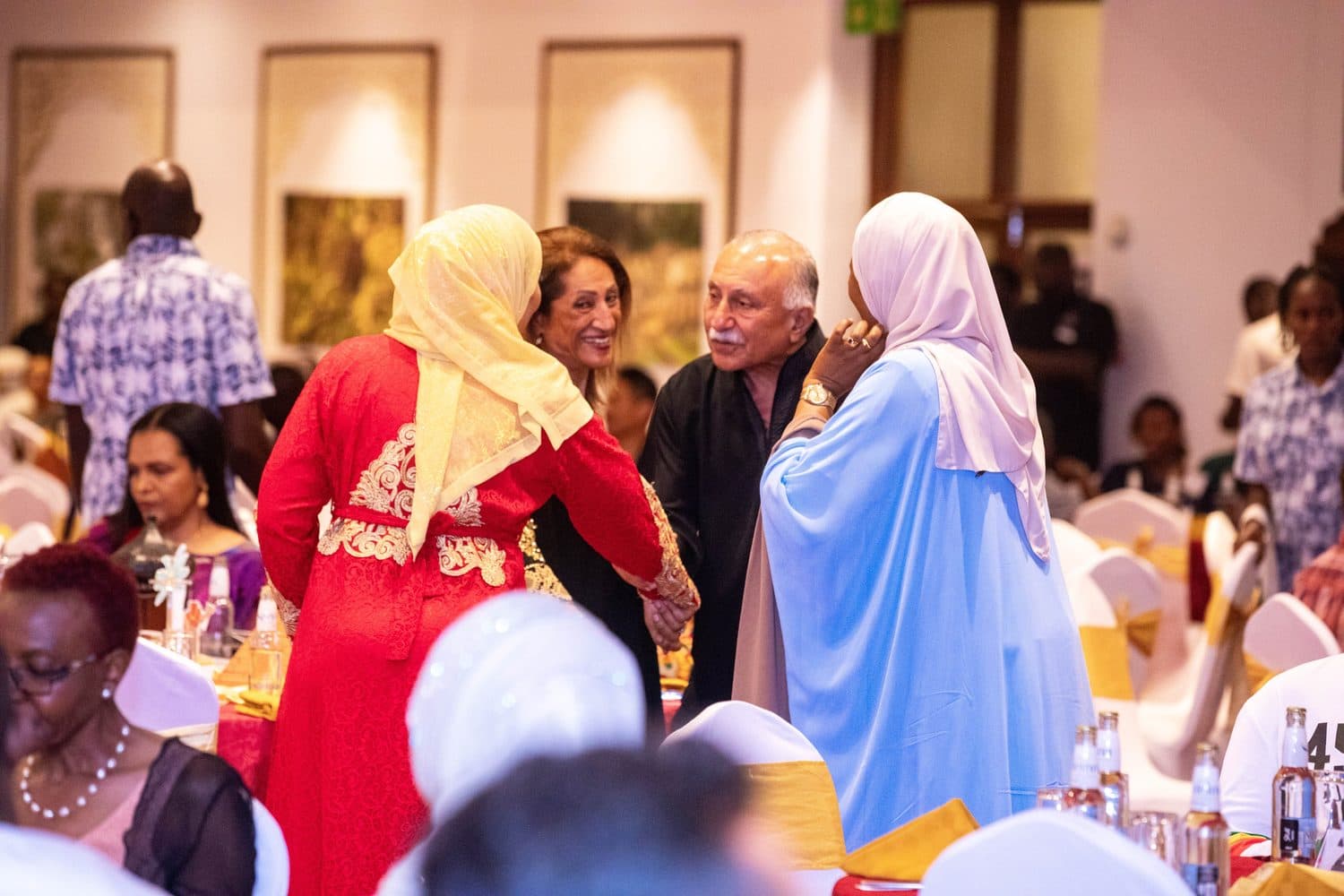 Guests seated at decorated dinner tables in the gala hall