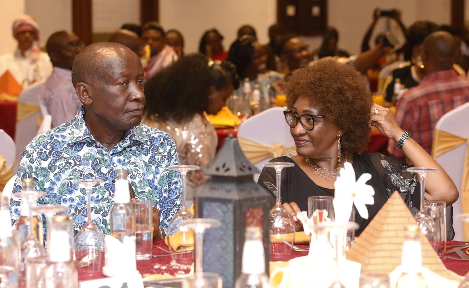 A guest sharing a moment over dinner at the gala