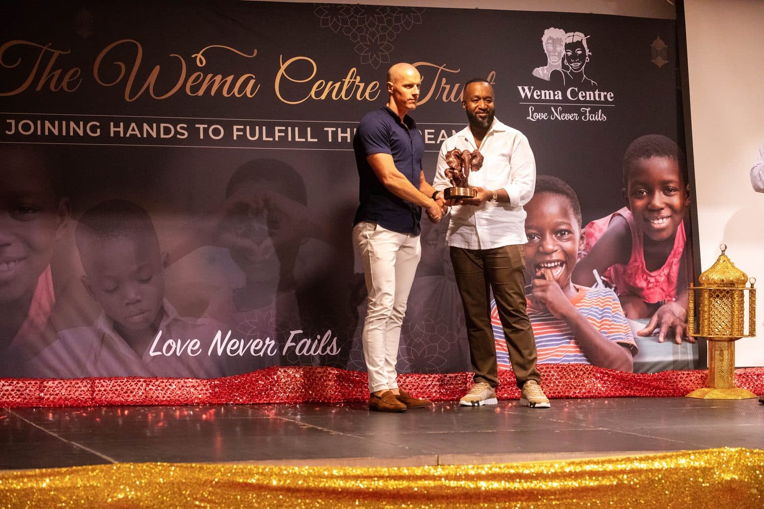 A presentation on stage beneath the Wema Centre backdrop