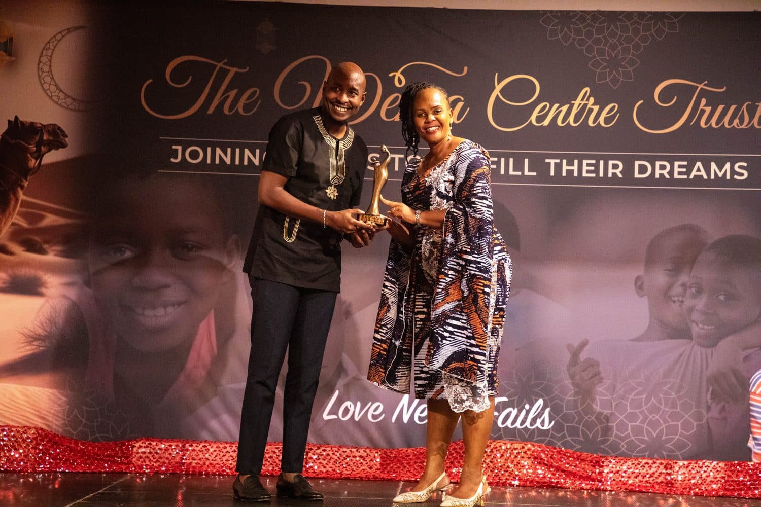 A couple presented on stage at the Wema Gala Dinner