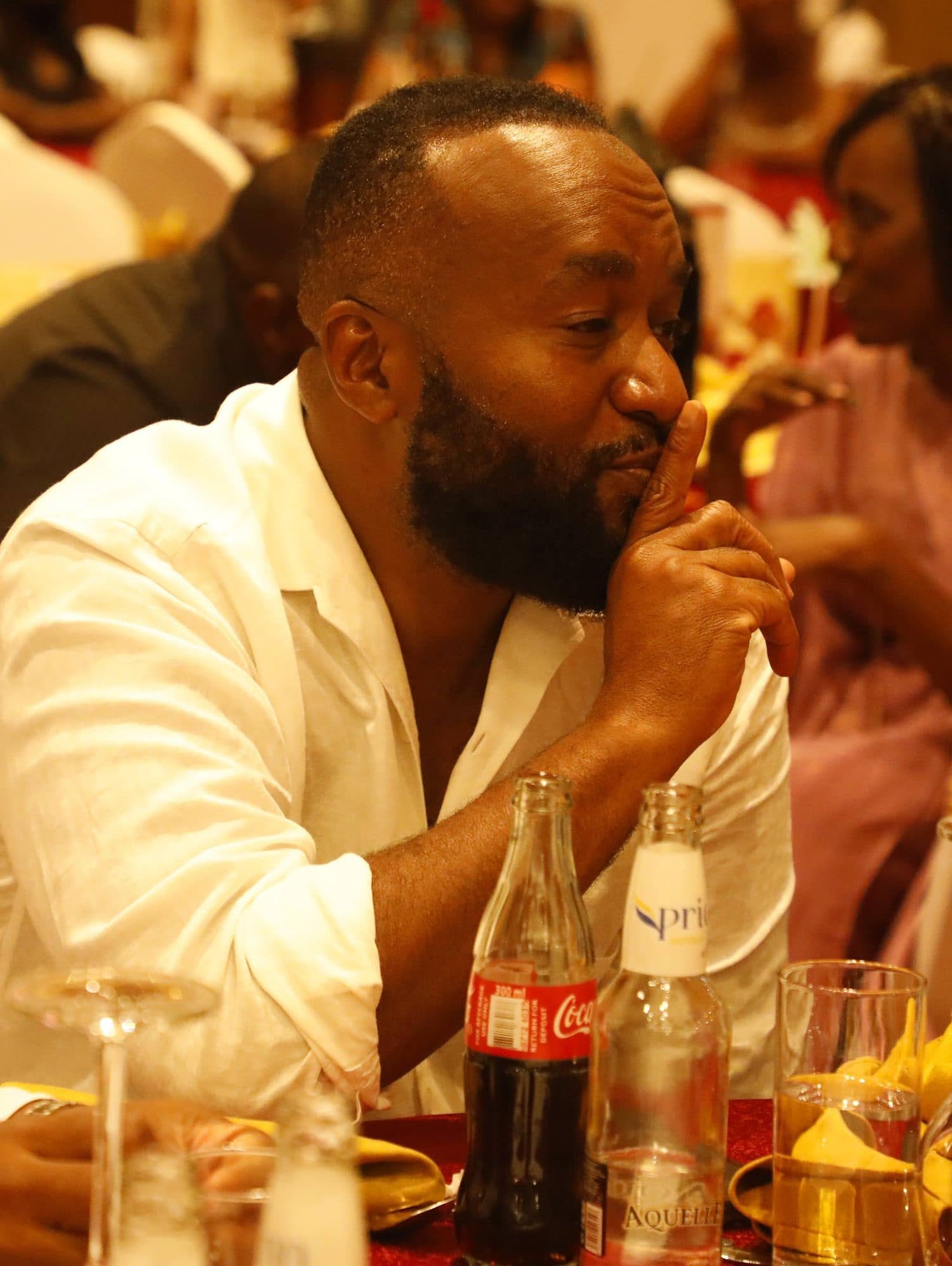 A host addressing the gathered guests at the gala