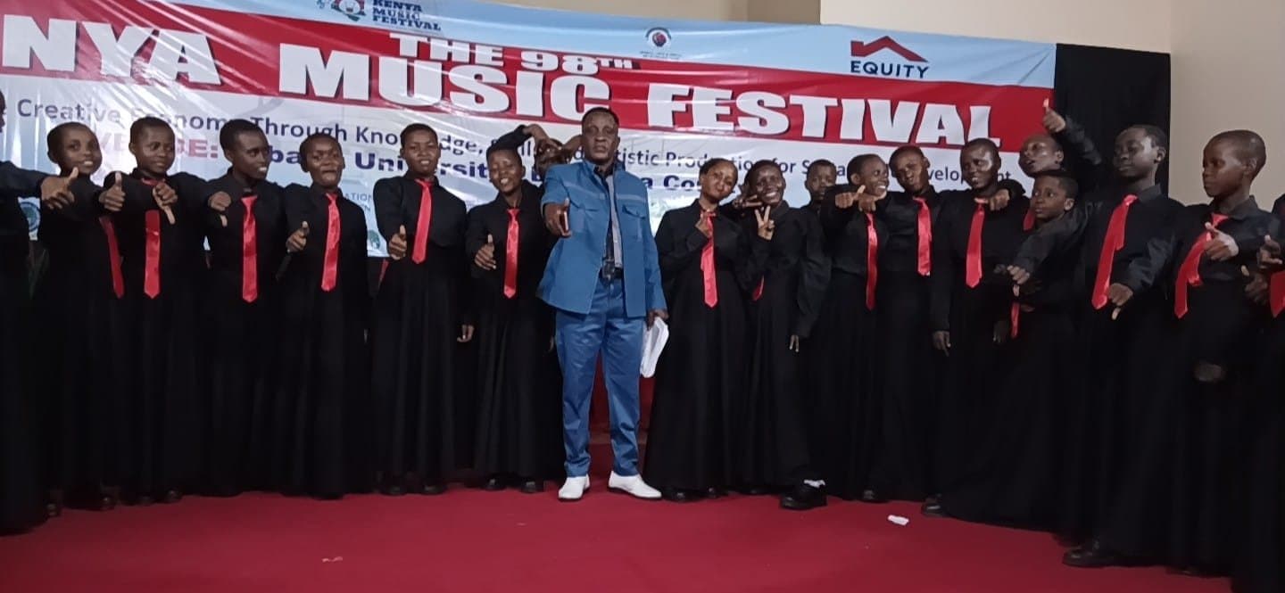 Wema Centre's choir performing in black gowns and red ties